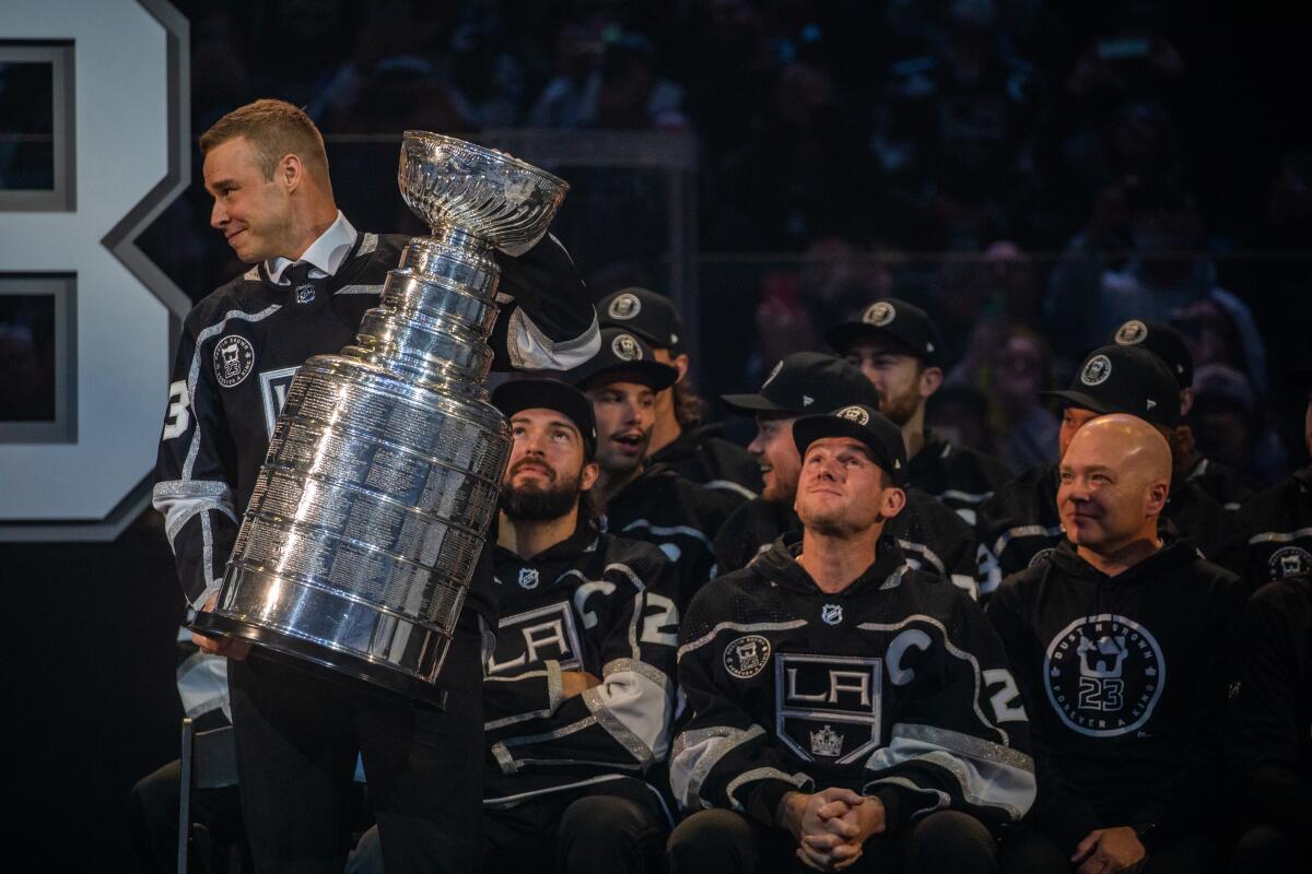 Dustin Brown holds the Stanley Cup during his jersey retirement ceremony Saturday at Crypto.com Arena.