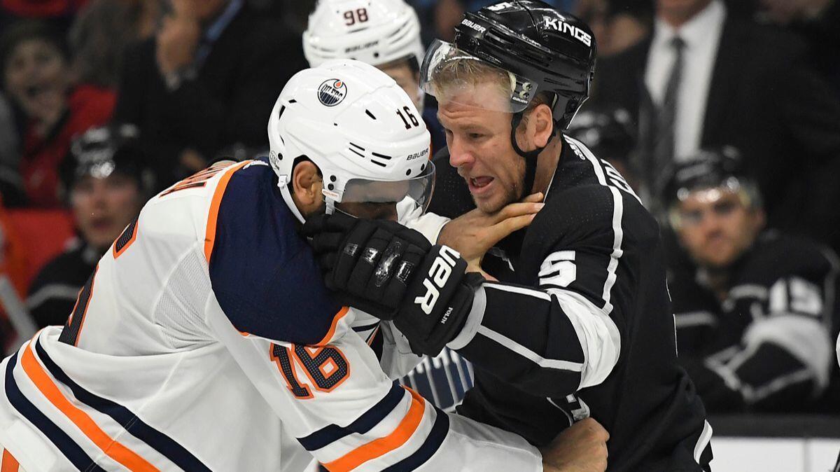Edmonton Oilers left wing Jujhar Khaira, left, and Kings defenseman Christian Folin fight during the first period on Wednesday.