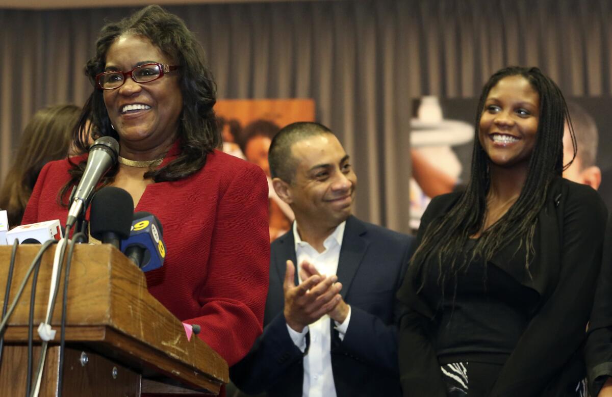 Michelle King, left, is introduced as the new superintendent of the Los Angeles Unified School District on Jan. 11, backed by board member Ref Rodriguez, center, and King's daughter Brittney King.