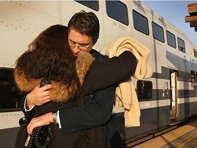 Regular rider Theresa Dunaway hugs Metrolink conductor Dalton Parker on Thursday, the day after a crash killed 11 people, including a colleague of Parker. Despite Wednesdays crash involving two trains, many rail commuters returned.