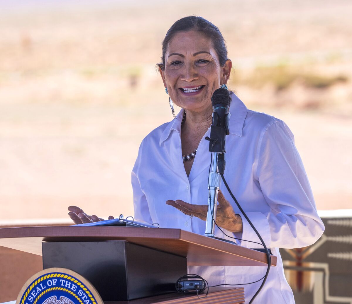 FILE - U.S. Secretary of the Interior Deb Haaland speaks after signing the agreement for the Navajo federal reserved water rights settlement at Monument Valley, Utah on Friday, May 27, 2022. Haaland has tested positive for COVID-19 on Wednesday, June 1, 2022 and has mild symptoms. The Interior Department said Haaland is isolating in Nevada where she was part of a roundtable discussion Tuesday on clean energy production on public lands. (Rick Egan/The Salt Lake Tribune via AP, File)