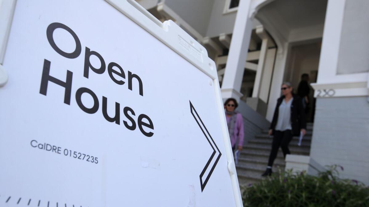 Real estate agents leave a home for sale during a broker open house in April in San Francisco.