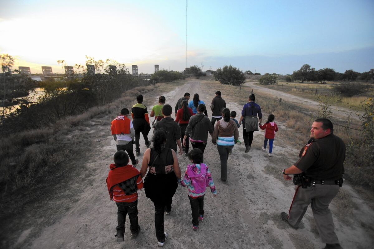 People from Guatemala are escorted by Border Patrol officials after crossing the Rio Grande into Texas last summer.