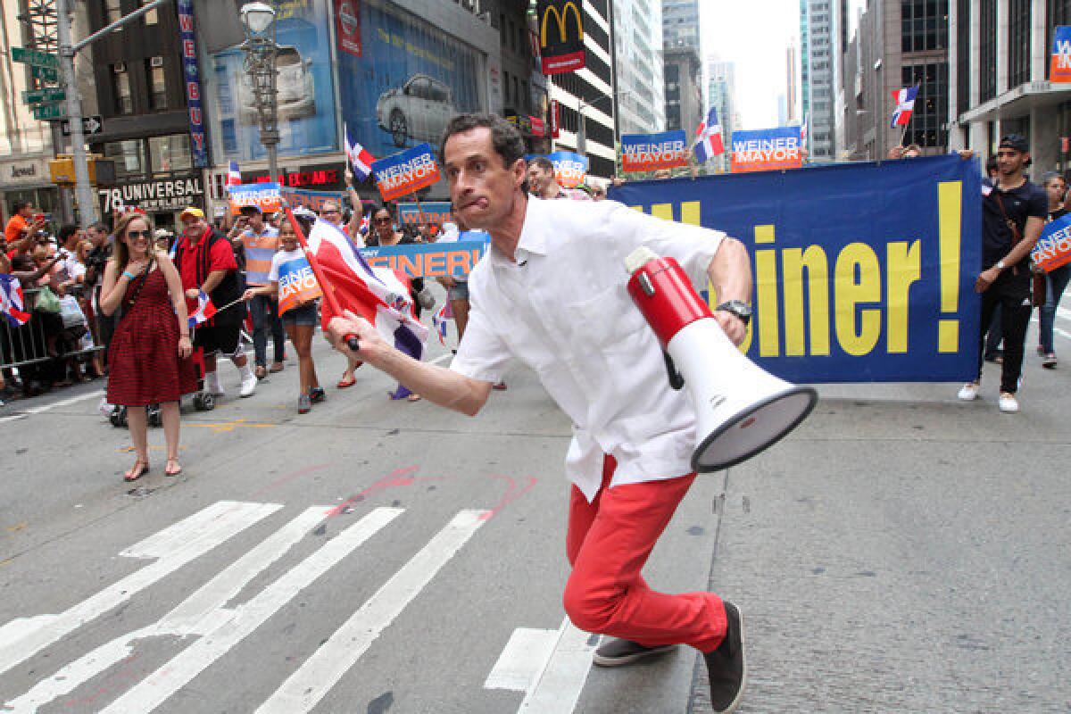 Anthony Weiner, running in New York's mayoral race, makes his way up New York's Avenue of the Americas as he takes part in the Dominican Day Parade on Sunday.
