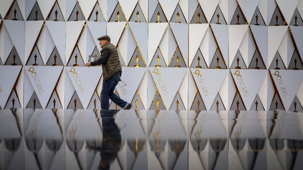 The step-and-repeat background along the red carpet is reflected along Hollywood Boulevard as preparations are made for the 90th Academy Awards, outside the Dolby Theatre in Hollywood.