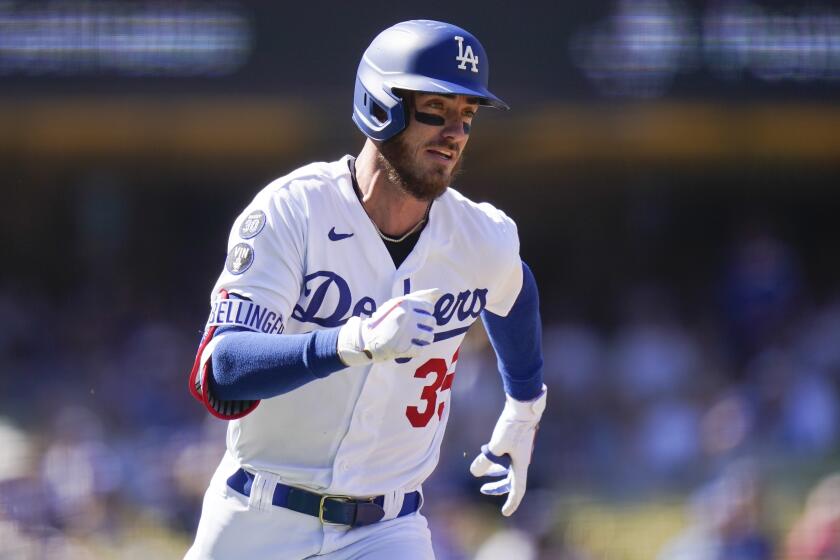 Los Angeles Dodgers' Cody Bellinger runs toward second base after hitting a double 