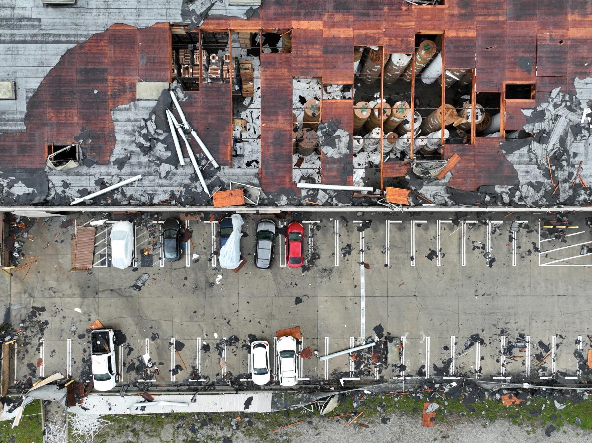 A warehouse roof with sections ripped off.