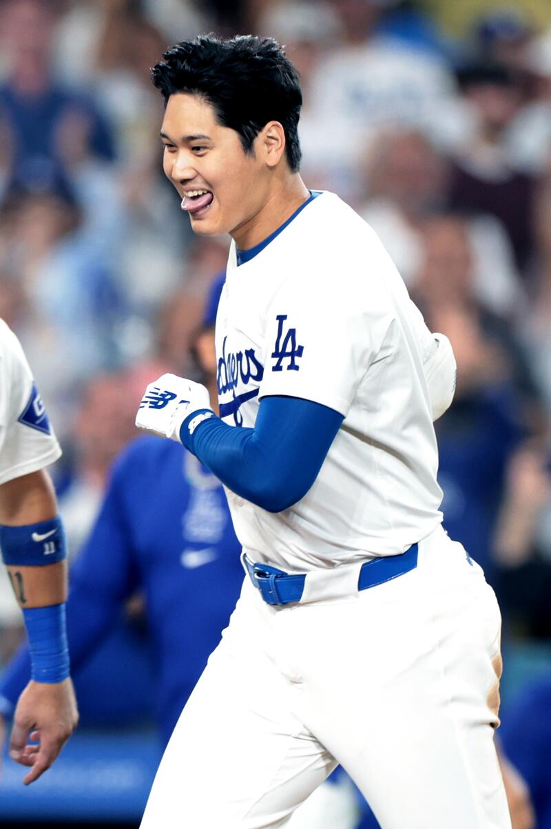 Shohei Ohtani smiles as he approaches home plate after hitting a walk-off grand slam against the Rays at Dodger Stadium on Friday night.