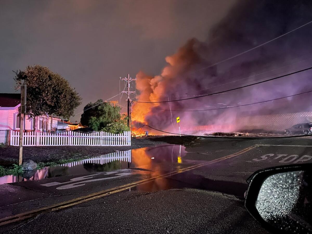 Smoke and flames rise in the air after a plane crashed in the unincorporated Bostonia neighborhood 