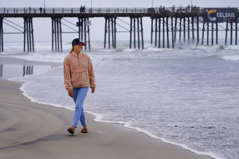 Oceanside, CA - September 17: Walking near the Oceanside Pier on Friday, Sept. 17, 2021 in Oceanside, CA., Alyssa Spencer, 18 of Encinitas will compete in the Super Girl Pro Junior this weekend. (Nelvin C. Cepeda / The San Diego Union-Tribune)