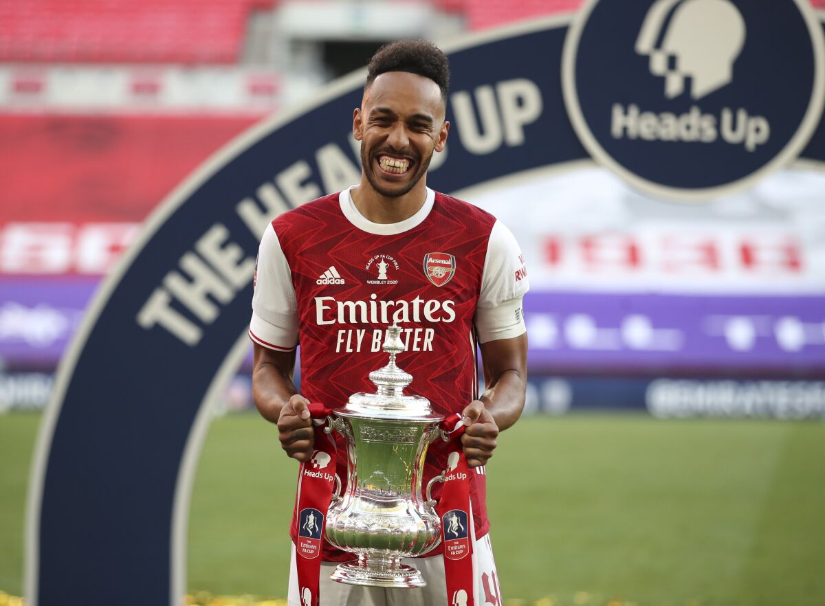 FILE - In this Saturday, Aug. 1, 2020 file photo, Arsenal's Pierre-Emerick Aubameyang celebrates with the trophy after the FA Cup final soccer match against Chelsea at Wembley stadium in London, England. Arsenal may have ended the season as FA Cup winners but their eighth-placed finish was their lowest in the Premier League since 1995 and head coach Mikel Arteta will have to steer his side through some tough early fixtures to give them a better chance of sealing a return to the top four. (Adam Davy/Pool via AP, file)