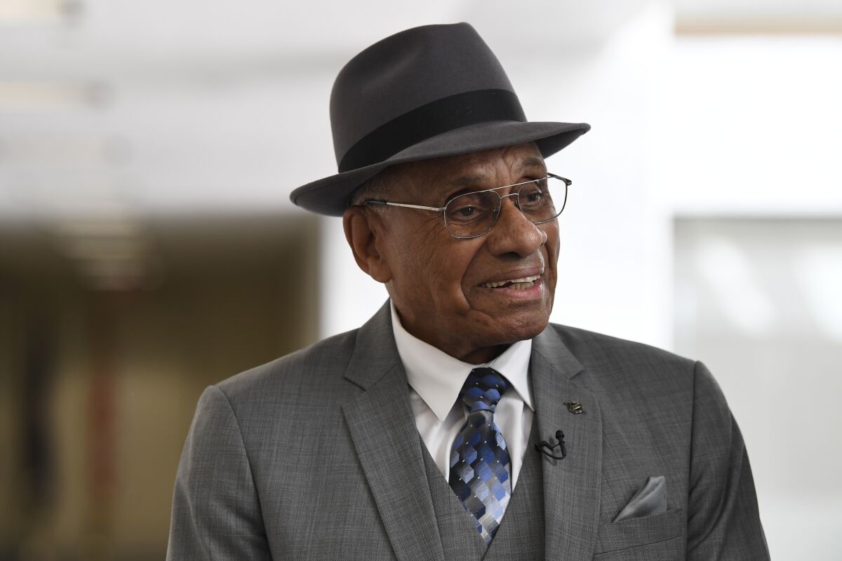 FILE - Willie O'Ree arrives for a meeting on Capitol Hill in Washington,July 25, 2019. O'Ree says the ongoing pandemic hasn't diminished what he says will be a "simply amazing" honor watching his No. 22 jersey retired by the Bruins. O'Ree, who broke the NHL's color barrier on Jan. 18, 1958, was slated to attend when he became the 12th player in team history to have his number retired prior to Boston's game against Carolina on Tuesday, Jan. 18, 2022. But persisting concerns about the pandemic changed those plans. He will now participate from his home in San Diego. (AP Photo/Susan Walsh, File)