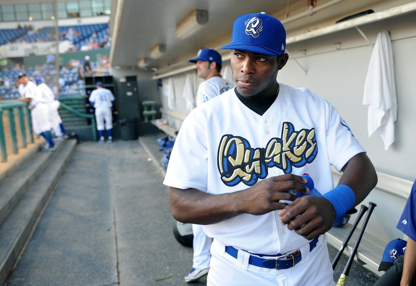 The Dodgers' Yasiel Puig tapes his wrists before a game. His journey to Los Angeles is a serpentine tale of drug cartels, nighttime escapes and international human smuggling.