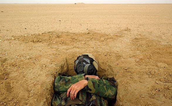 On the first day of the invasion, after U.S. forces launched a thundering bomb and missile attack on Baghdad at dawn, in neighboring Kuwait, Marine Cpl. Philip Sturm hunkers down amid reports of Iraqi missile attacks and artillery fire. U.S. ground forces are stationed there as they await orders to deploy. See 'Sirens, Booms, a Call to Prayer' for a Times' report on the first moments of the invasion from the ground in Baghdad. How did the U.S. get to this point? Read the Times' 'Iraq Demystified: a Primer on Politics, History' for a quick tutorial.