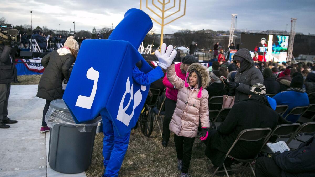 "Dreidel Man" greets a young attendee during the annual National Menorah Lighting ceremony in Washington on Dec. 12.