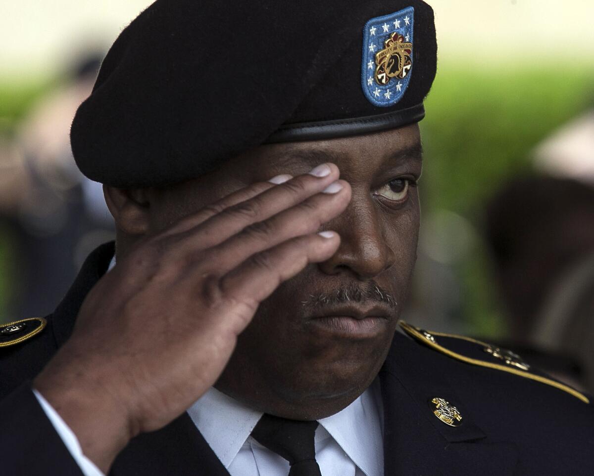 Purple Heart recipient Staff Sgt. Paul Martin salutes as the colors are posted during a Purple Heart ceremony held at Ft. Hood, Texas, on April 10.