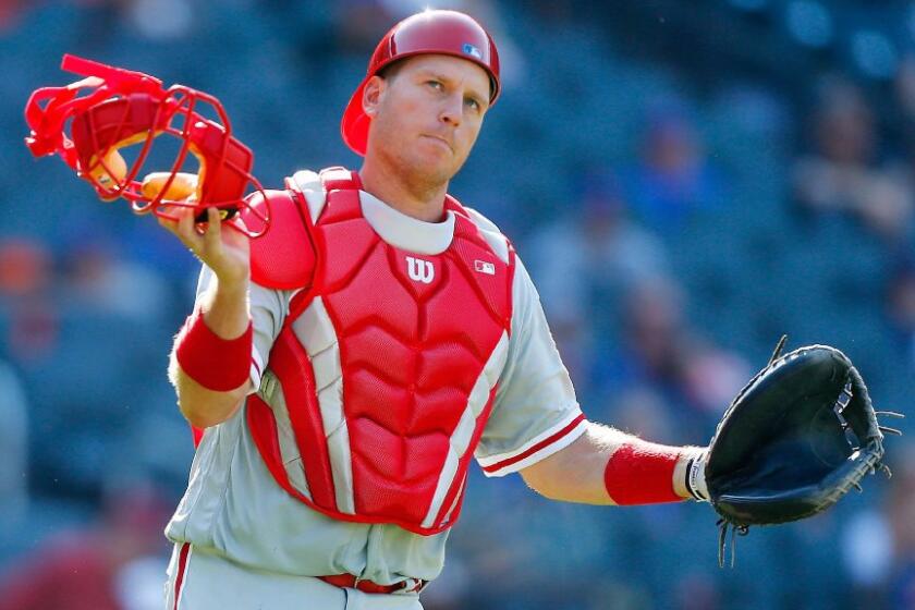Former Dodgers catcher A.J. Ellis plays in the red of the Philadelphia Phillies after the Dodgers traded him away in August. The Times' Pedro Moura and Andy McCullough discuss the the value of Ellis, who was a favorite of Dodgers teammates and fans.