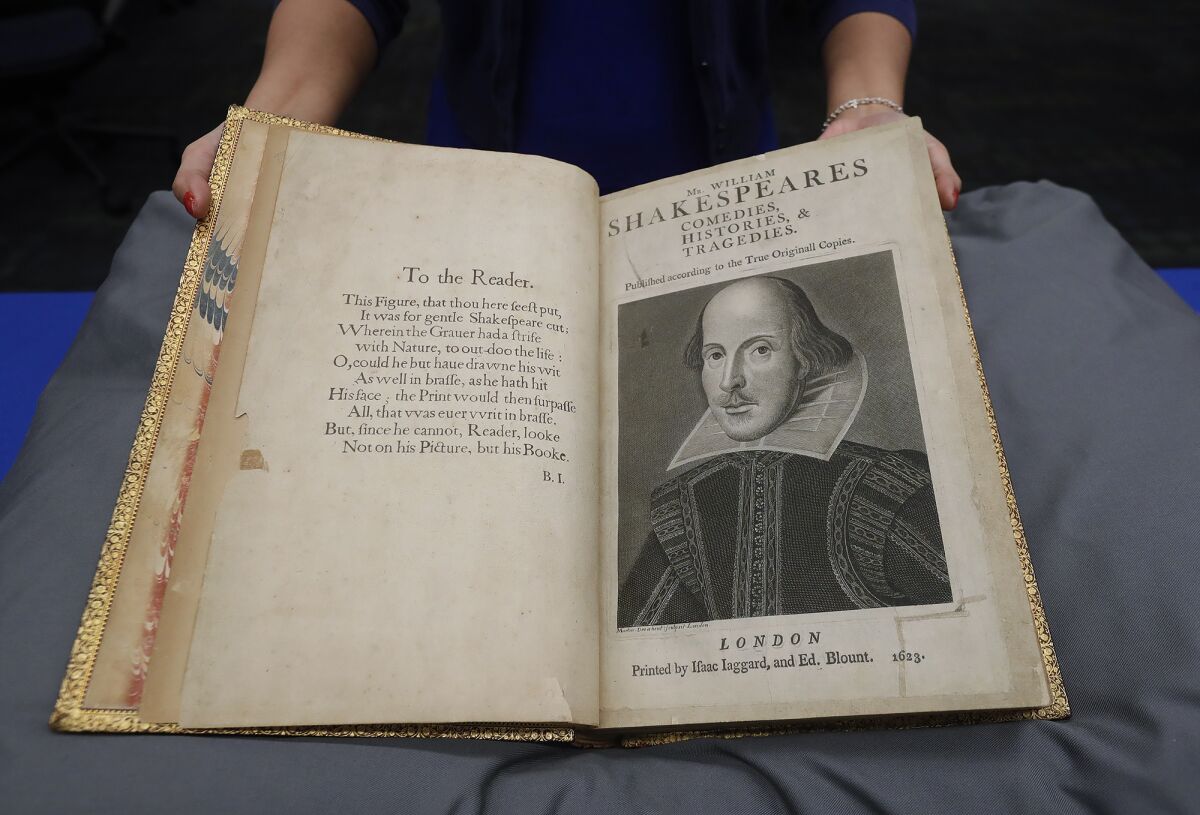 Hanako Ishizuka-Gunderson shows the opening pages of a copy of 1623 Shakespeare's First Folio at UCI's Langson Library.