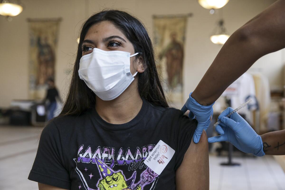 A young woman gets a shot