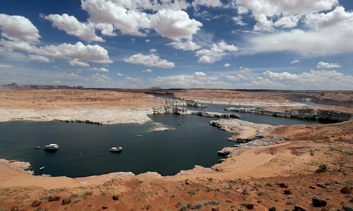 Boats float on Lake Powell, a vast reservoir of Colorado River water situated near the Utah-Arizona border.