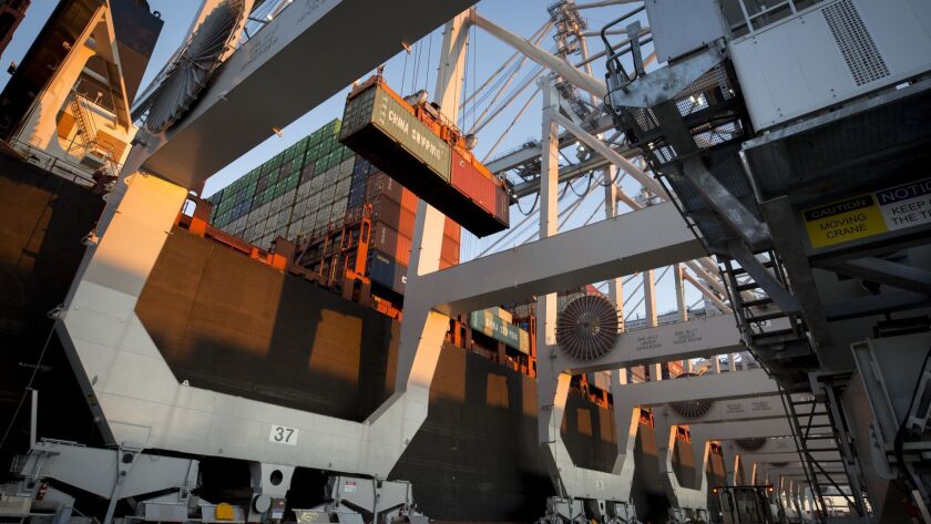 A crane loads shipping containers onto a vessel at the Port of Savannah in Savannah, Ga. on Jan. 30.