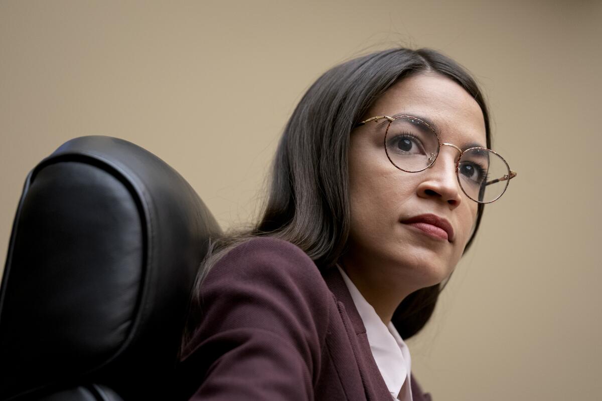 A head-and-shoulders view of a woman sitting in a black office chair