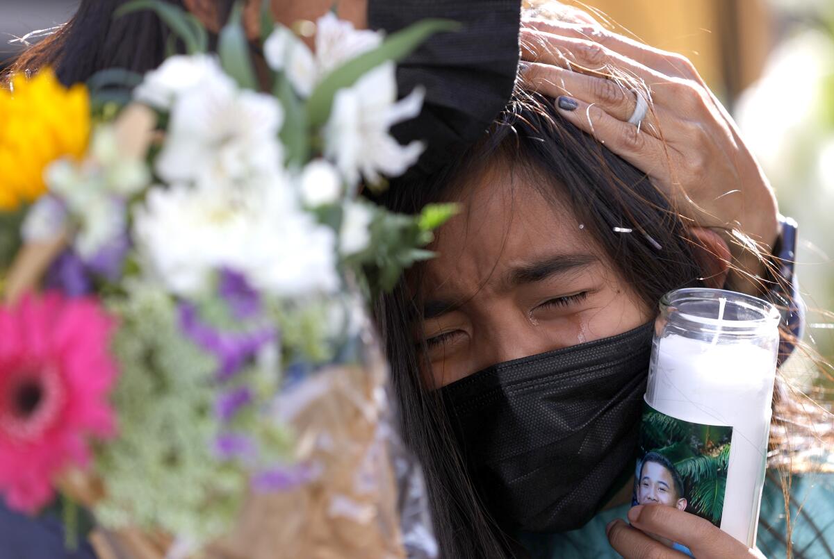 Avery Megia cries at a vigil for the nine victims of a shooting in San Jose, including her father.