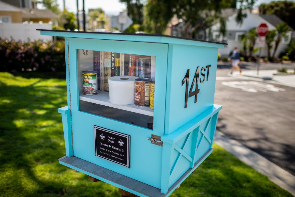 A lending library included some additional useful items, including a roll of toilet paper and cans of beans and corn, in a Hermosa Beach neighborhood on Sunday.