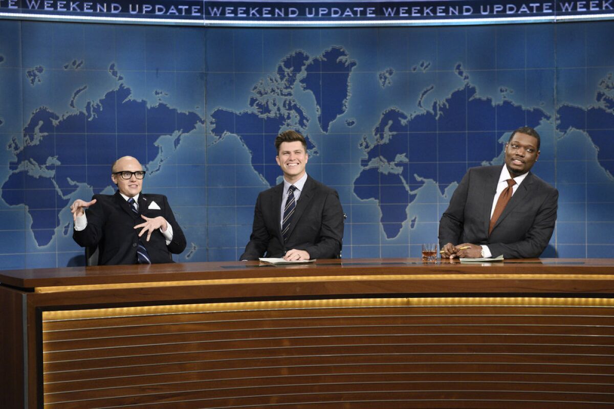Kate McKinnon as Rudy Giuliani, left, Colin Jost and Michael Che in “Saturday Night Live.”