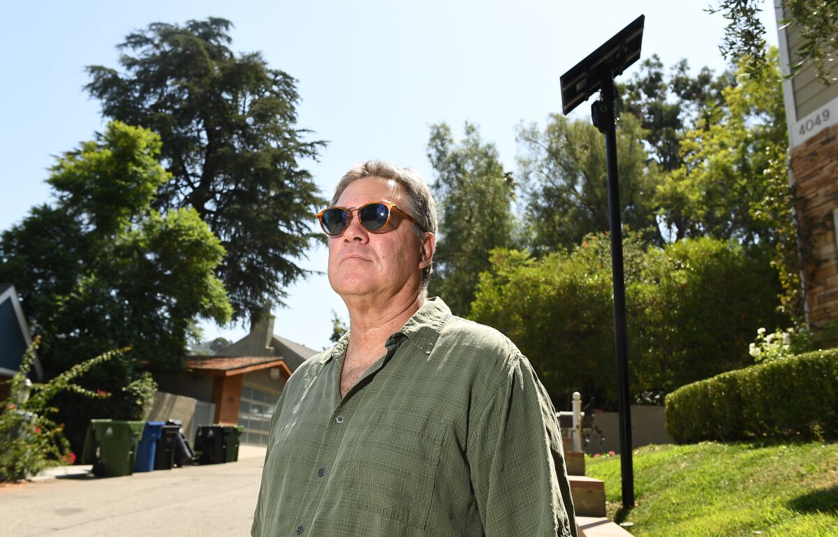Robert Shontell stands along a street in Sherman Oaks where security cameras are installed to read license plates.