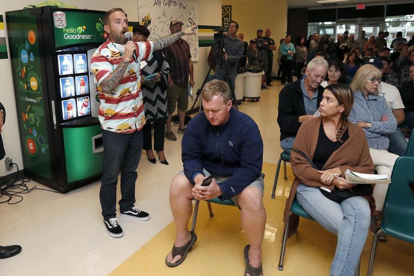 Huntington Beach resident Ryan Messick voices his concerns during a questions and answers session at a second community meeting Thursday evening at Edison High School. State and regional air quality officials talked through how they are handling the 18-month cleanup that is currently underway at the former Ascon landfill in Huntington Beach.