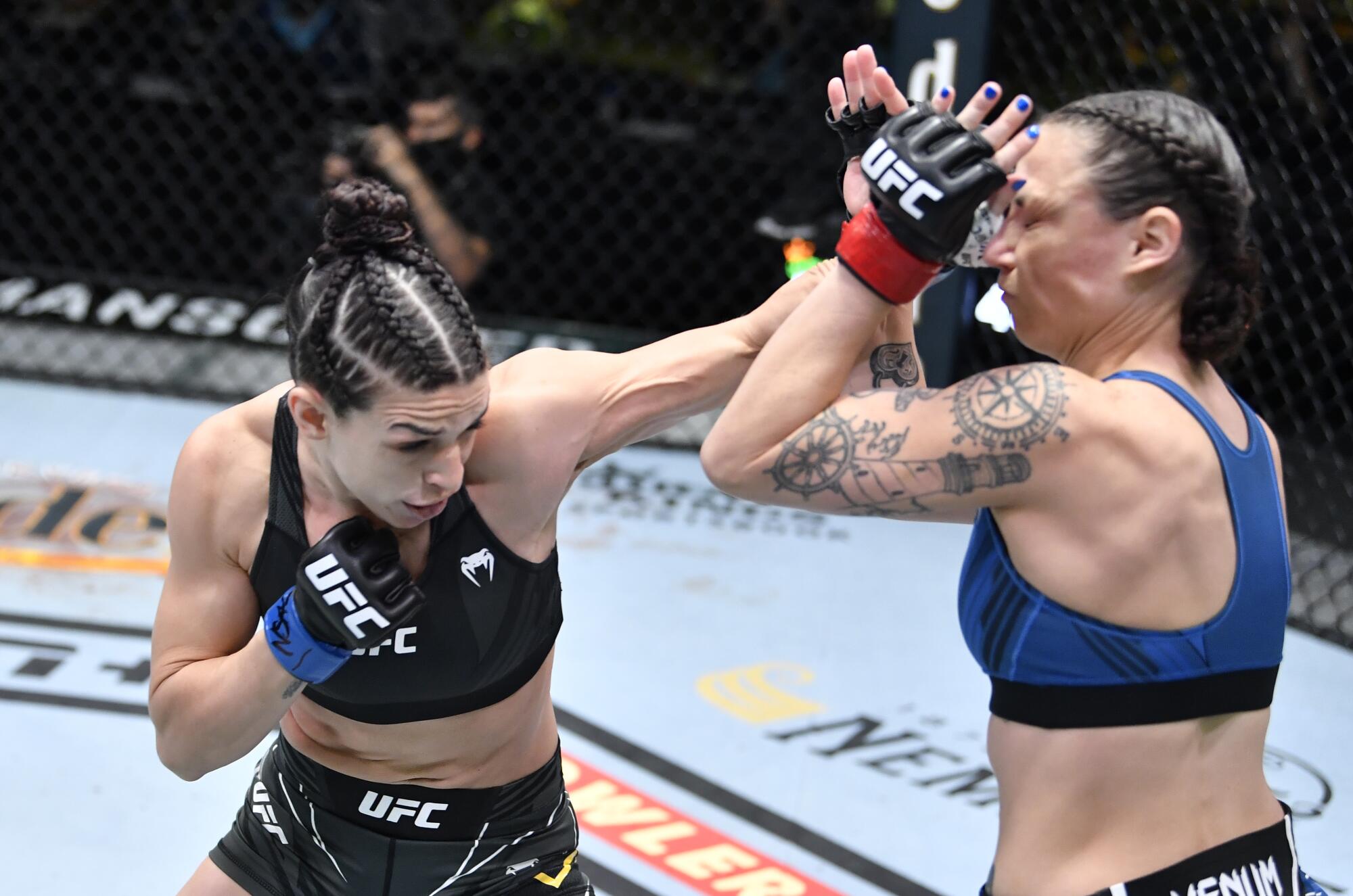 LAS VEGAS, NEVADA - APRIL 10: (L-R) Mackenzie Dern punches Nina Nunes.