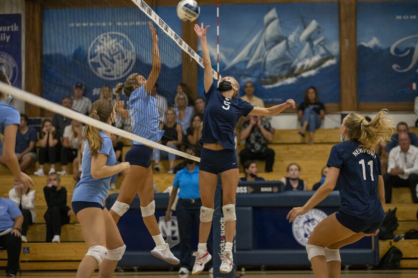 Newport Harbor's Tegan Glenn goes up against Corona del Mar's Anabelle Frazier at the net on Wednesday.