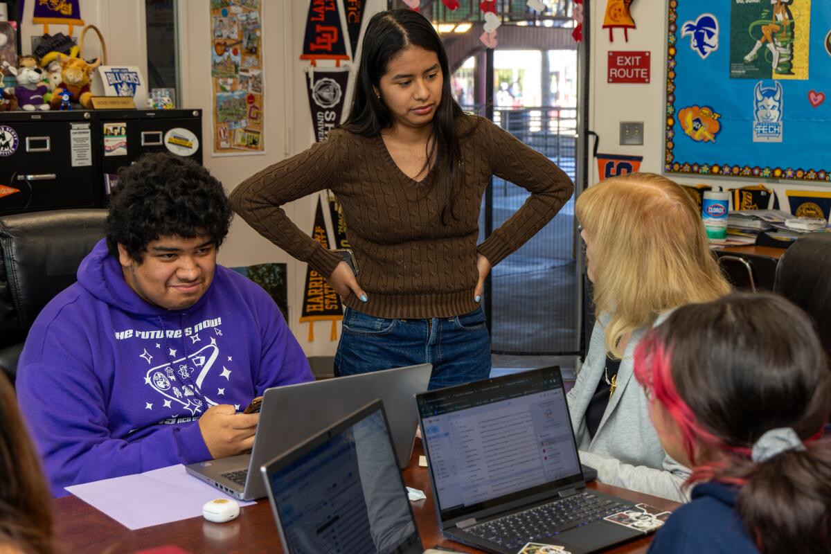 Students talk to counselor Lynda McGee at Downtown Magnets High School.