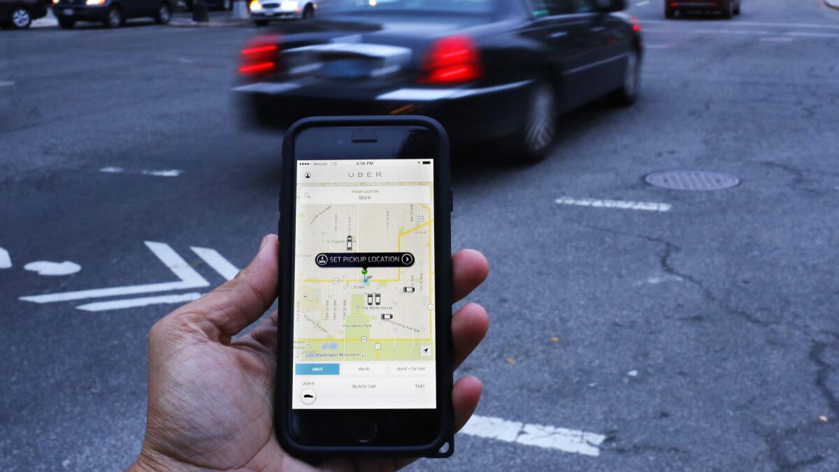 An Uber user in Washington, D.C., awaits his ride in March 2015. (Andrew Caballero-Reynolds / AFP/Getty Images)