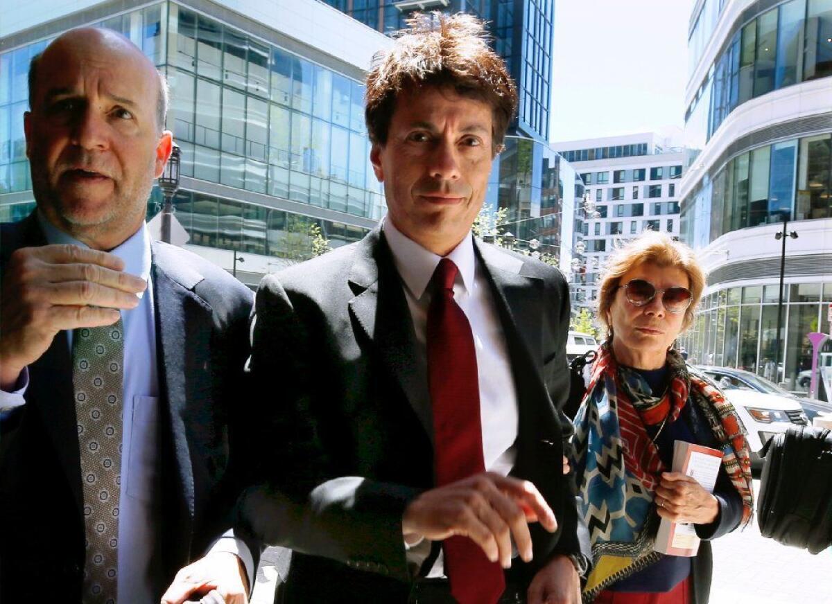 Agustin Huneeus, center, arrives at federal court in Boston on May 21.