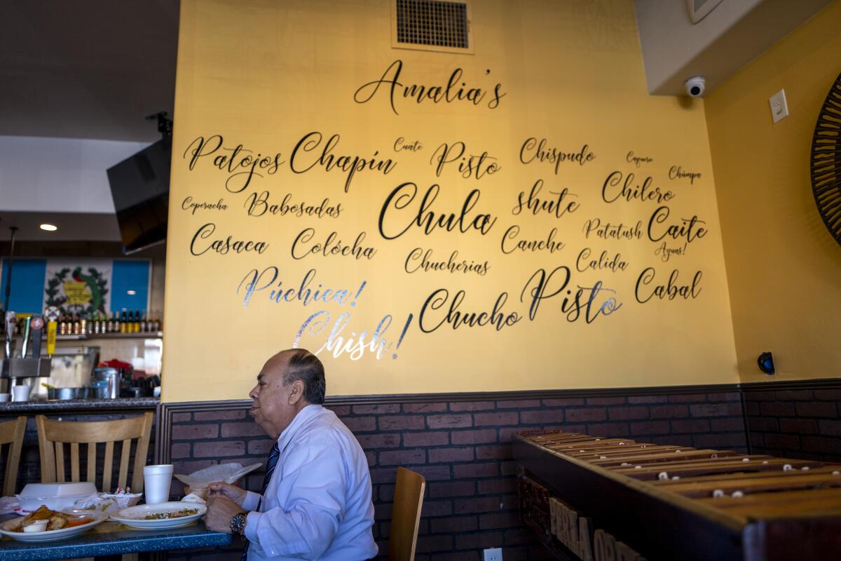 A man sits at a restaurant table with food on it