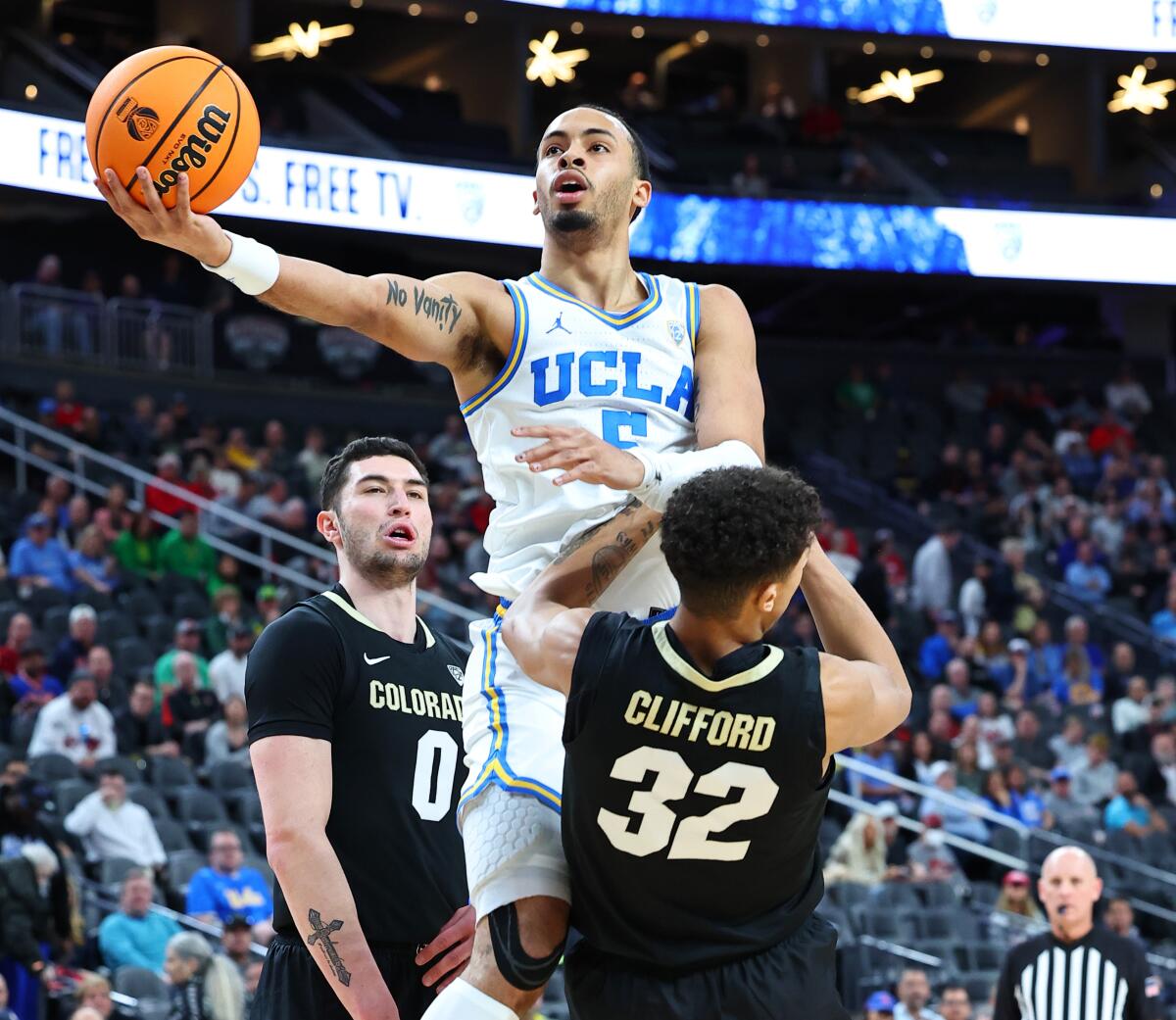 UCLA guard Amari Bailey drives to the basket over Colorado's Nique Clifford.