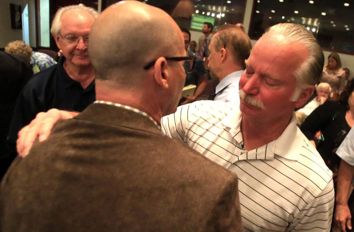 Ron Thomas, right, the father of Kelly Thomas, after Orange County supervisors voted to implement Laura's Law.
