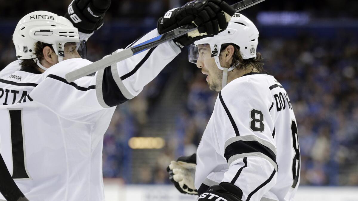 Kings defenseman Drew Doughty, right, celebrates with teammate Anze Kopitar after scoring during the first period of a 4-2 win over the Tampa Bay Lightning on Saturday.