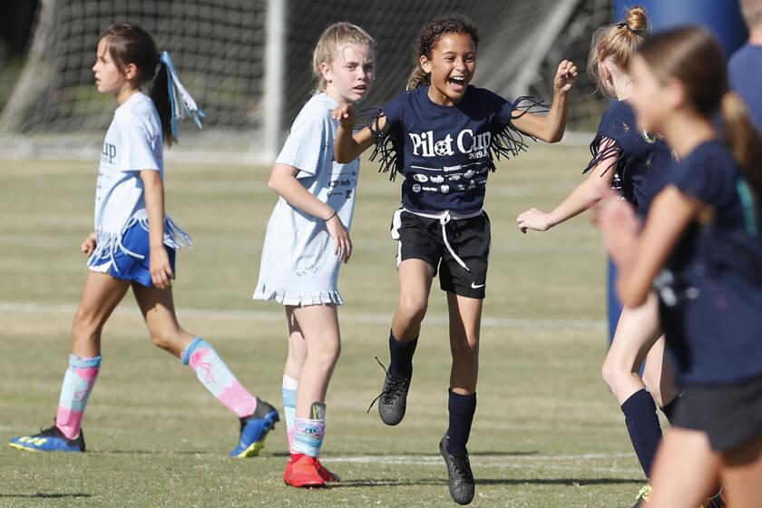 Newport Beach Mariners Elementary's Arianna Presley, center, celebrates after scoring a goal against Newport Beach Andersen in a girls' third- and fourth-grade Gold Division pool-play match at the Daily Pilot Cup on Wednesday at Jack R. Hammett Sports Complex in Costa Mesa.