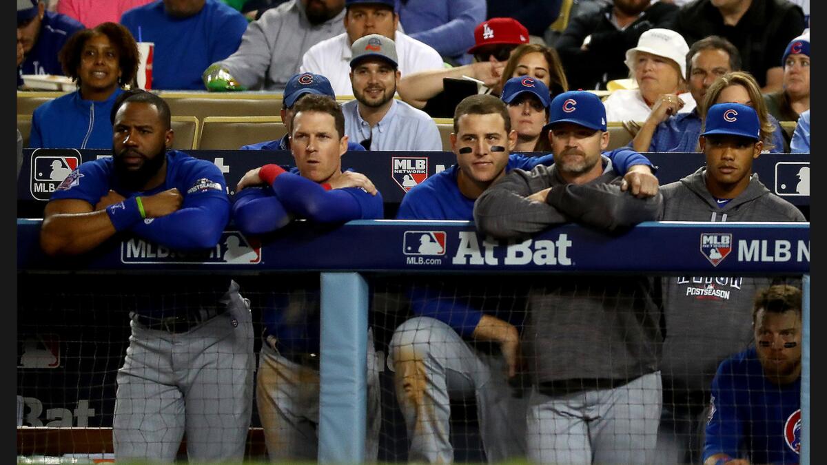 Cubs players watch as the Dodgers shut them out 6-0 in Game 3 of the NLCS at Dodger Stadium.