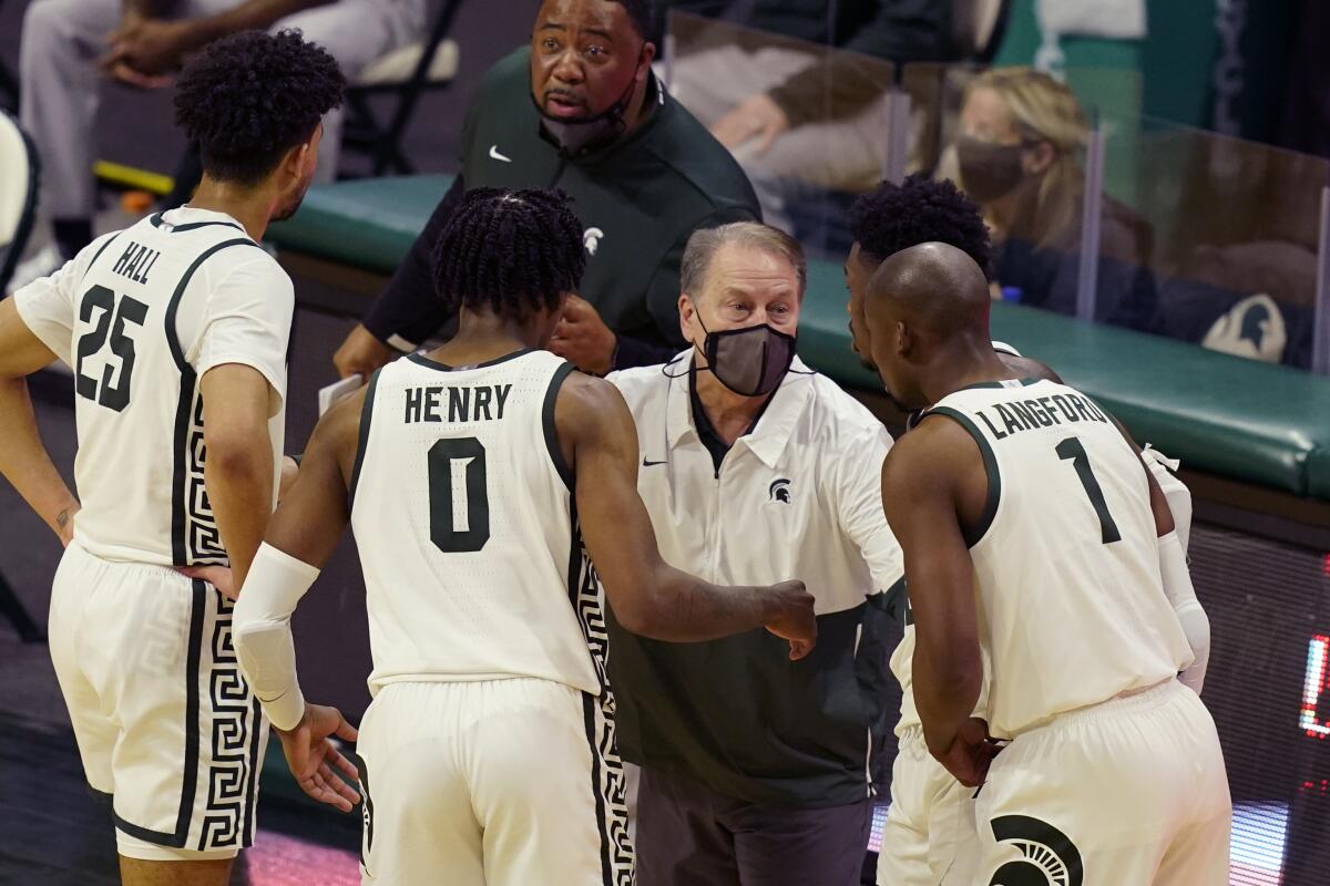 Michigan State coach Tom Izzo speaks with his players during a game on March 7.
