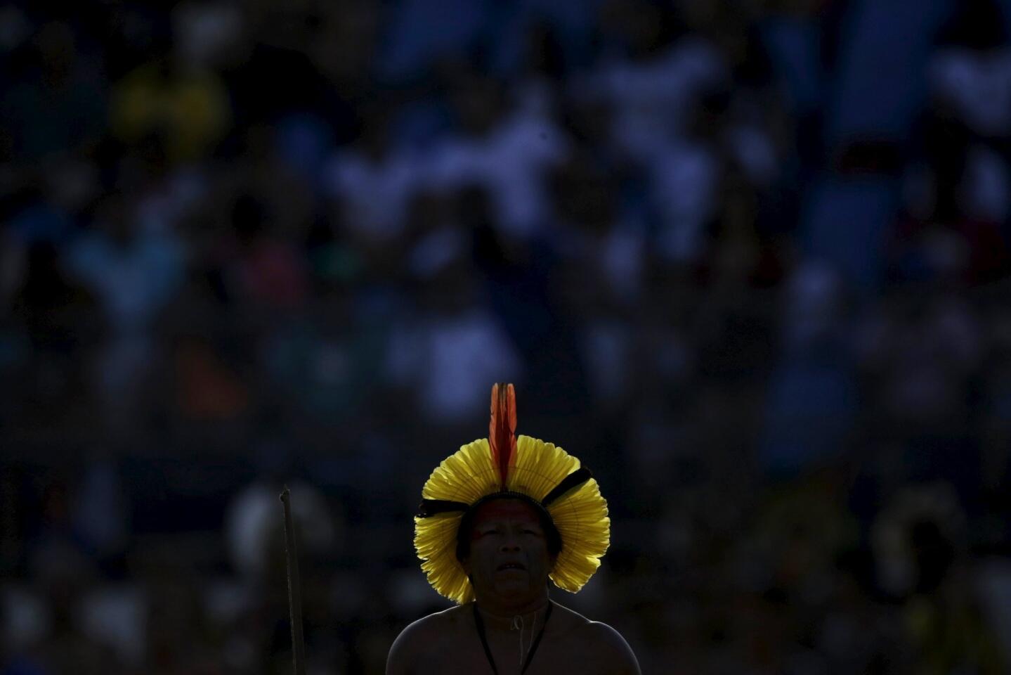 An indigenous man from the Kayapo people walks during the bow-and-arrow competition at the first World Games for Indigenous Peoples in Palmas