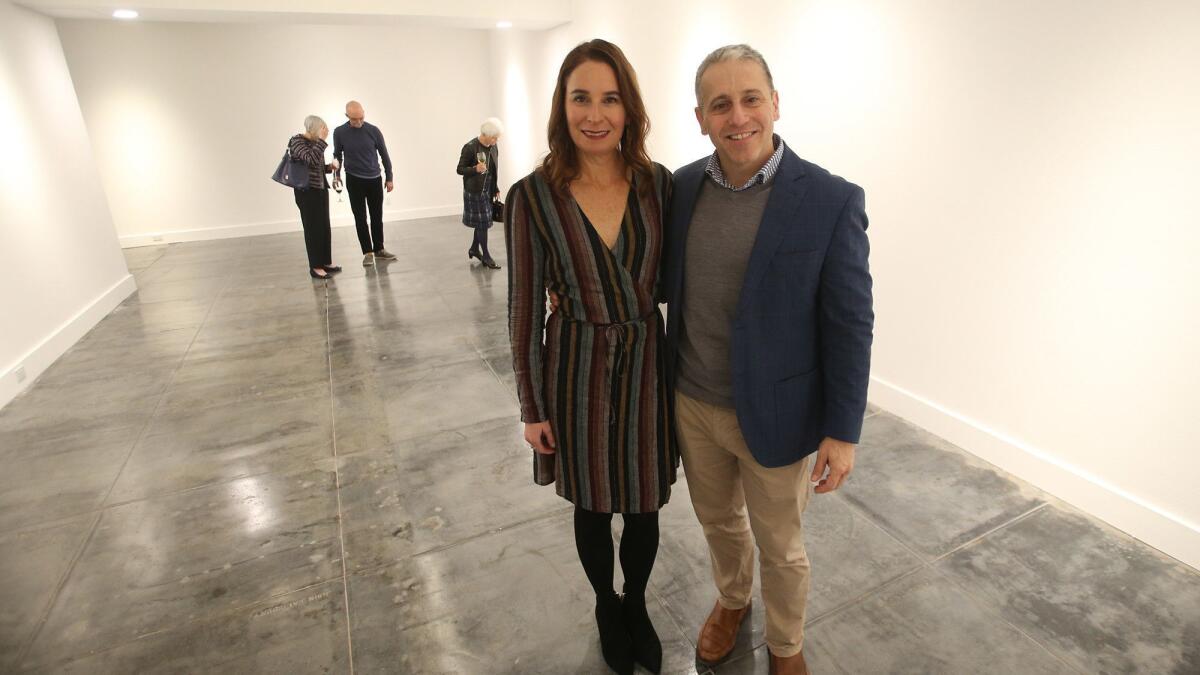 Project architect Anders Lasater and his wife, Cynthia, stand on the newly restored floor of the lower level of the Laguna Art Museum on Thursday.