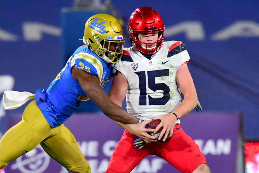 PASADENA, CA - NOVEMBER 28: Defensive back Obi Eboh #22 of the UCLA Bruins strips the ball.