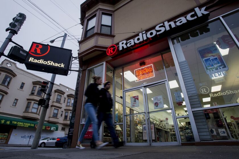 RadioShack continues to struggle in its turnaround efforts. The Texas company on Tuesday reported its ninth consecutive quarterly loss. Above, pedestrians walk past a RadioShack outlet in San Francisco last week.