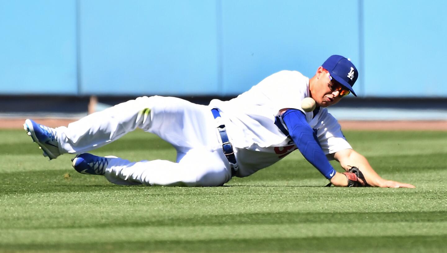 Dodgers center fielder Joc Pederson dives but can't make the catch on a single by Diamondbacks' Chris Owings in the fifth inning.