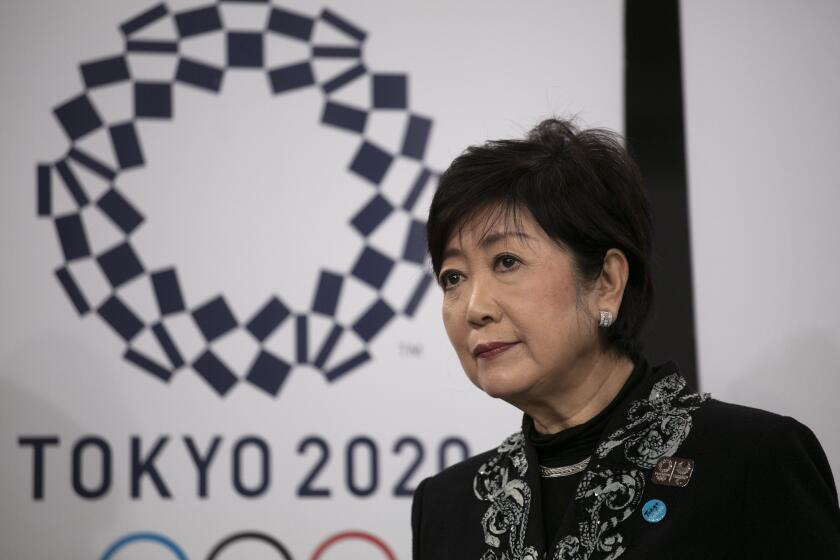 Tokyo Governor Yuriko Koike listens to questions from the media after a grand opening ceremony of the Ariake Arena, a venue for volleyball at the Tokyo 2020 Olympics and wheelchair basketball during the Paralympic Games, Sunday, Feb. 2, 2020, in Tokyo. (AP Photo/Jae C. Hong)