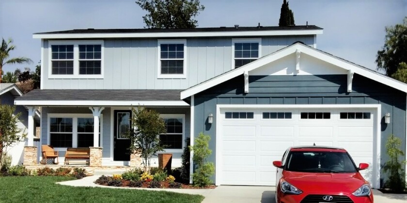 Hyundai Susie Conway sits in the driveway of her new home in Santi - The car and house were gifts from Ellen DeGeneres.